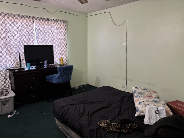 carpeted bedroom with ceiling fan and a textured ceiling