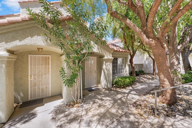 37940 E 42nd St Apt 115, Palmdale, CA 93552 - property entrance with stucco siding, a tile roof, and a patio