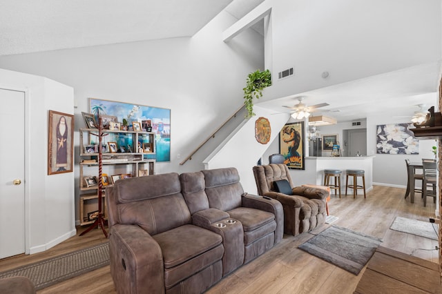 37940 E 42nd St Apt 115, Palmdale, CA 93552 - living room with wood finished floors, ceiling fan, high vaulted ceiling, baseboards, and stairs