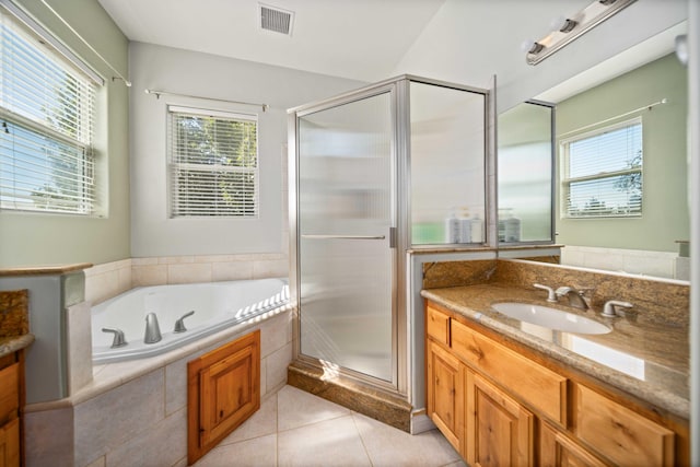 bathroom with tile patterned floors, vanity, and plus walk in shower