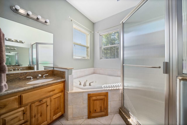 bathroom featuring tile patterned flooring, vanity, and separate shower and tub