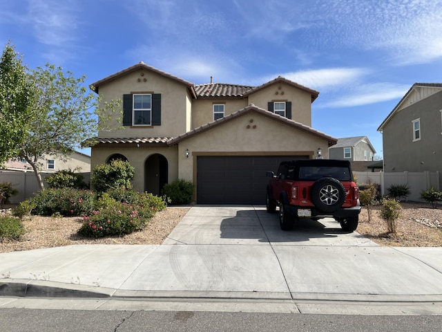 3544 Garnet Ln, Lancaster, CA 93535 - mediterranean / spanish house featuring stucco siding, fence, concrete driveway, a tile roof, and a garage