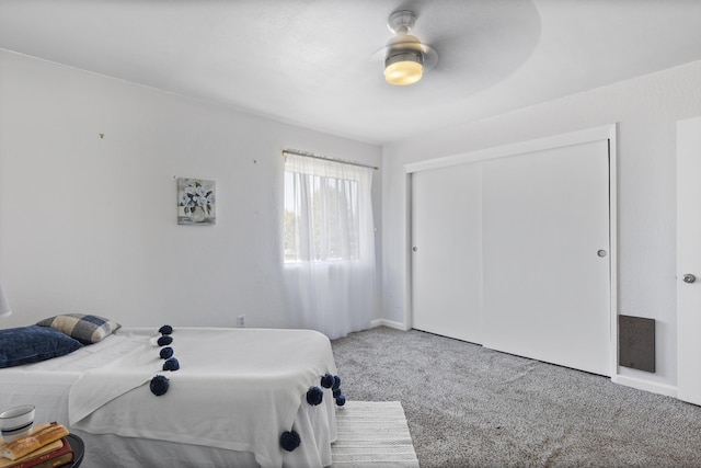 bedroom featuring ceiling fan, a closet, and carpet floors