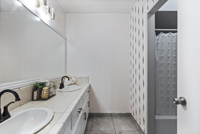 bathroom featuring tile patterned flooring, vanity, and shower / tub combo