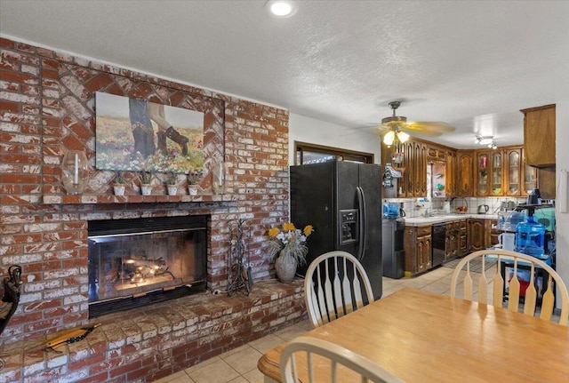 21104 Hillcrest Ct, Tehachapi, CA 93561 - dining room featuring light tile patterned floors, ceiling fan, a textured ceiling, and a brick fireplace