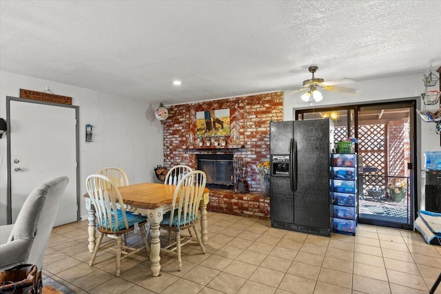21104 Hillcrest Ct, Tehachapi, CA 93561 - dining space with a textured ceiling, a ceiling fan, a brick fireplace, and light tile patterned floors