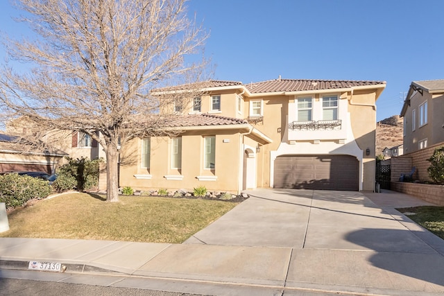 mediterranean / spanish house with a front yard and a garage