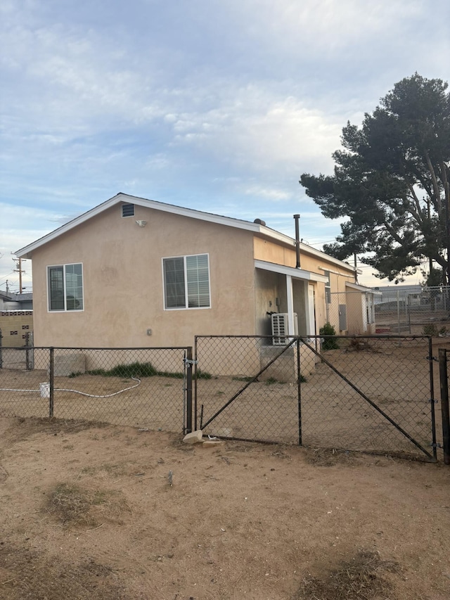 26920 Cote St, Boron, CA 93516 - view of front of house with stucco siding, fence, and a gate