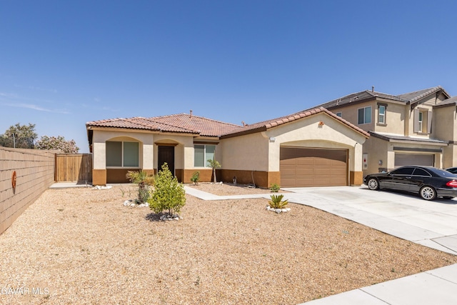 2038 Howard St, Rosamond, CA 93560 - mediterranean / spanish house with stucco siding, driveway, a tiled roof, and a garage