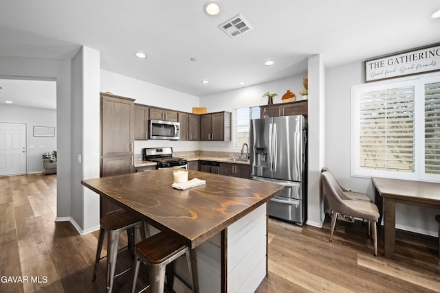 2038 Howard St, Rosamond, CA 93560 - kitchen featuring stainless steel appliances, dark brown cabinets, dark wood-style floors, recessed lighting, and butcher block counters