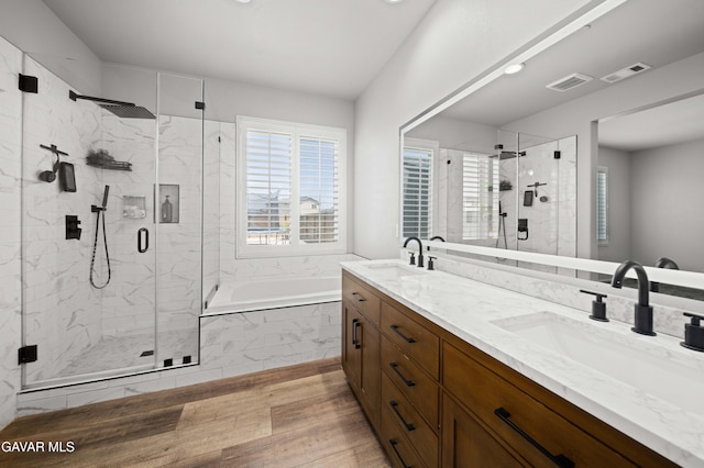2038 Howard St, Rosamond, CA 93560 - bathroom with a bath, wood finished floors, double vanity, and a shower stall