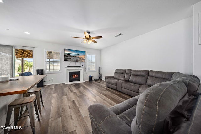 2038 Howard St, Rosamond, CA 93560 - living room with wood finished floors, a ceiling fan, a warm lit fireplace, and recessed lighting