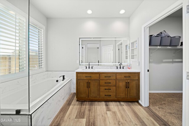 2038 Howard St, Rosamond, CA 93560 - full bath featuring double vanity, a bath, a spacious closet, wood finished floors, and recessed lighting