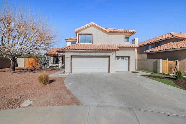 mediterranean / spanish-style house featuring concrete driveway, fence, a tile roof, and stucco siding