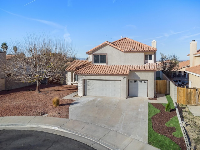 mediterranean / spanish-style home with a garage, concrete driveway, a tiled roof, fence, and stucco siding