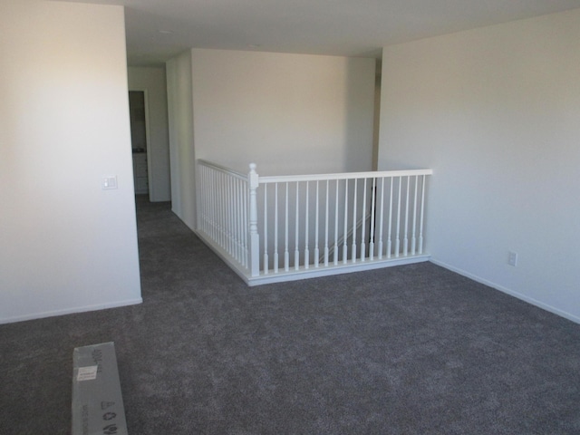 carpeted spare room with baseboards