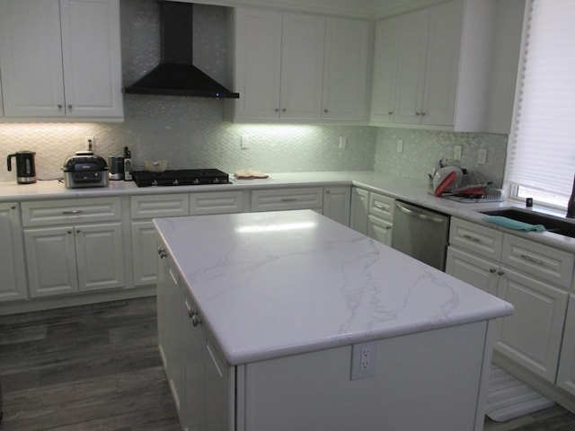 kitchen with black gas cooktop, white cabinetry, wall chimney range hood, stainless steel dishwasher, and dark wood-style floors