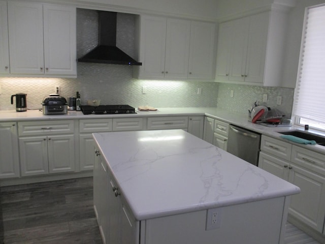 kitchen with black gas cooktop, wall chimney exhaust hood, white cabinetry, and dishwasher