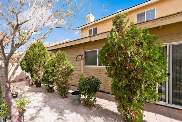 view of side of home featuring a patio area