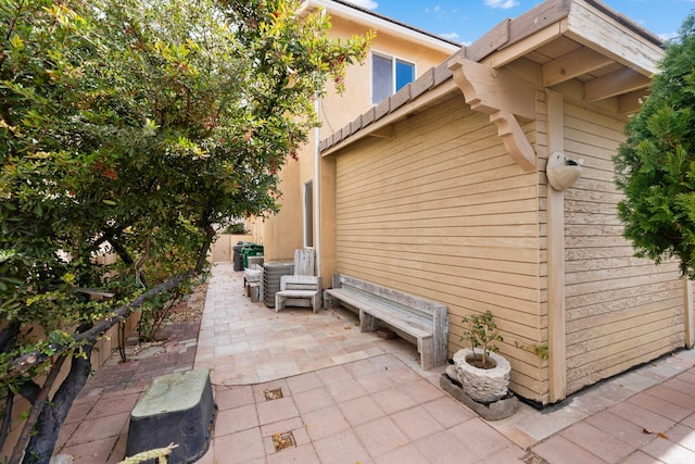 view of side of home with a patio area