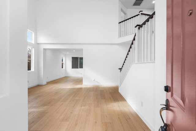 entrance foyer featuring a high ceiling and light wood-type flooring