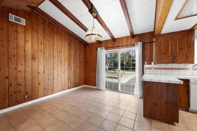 40836 W 36th St, Palmdale, CA 93551 - unfurnished dining area with light tile patterned floors, wood walls, and a chandelier