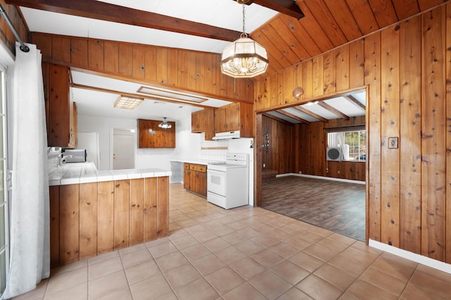 40836 W 36th St, Palmdale, CA 93551 - kitchen featuring white range with electric cooktop, tile counters, a chandelier, wood walls, and brown cabinetry