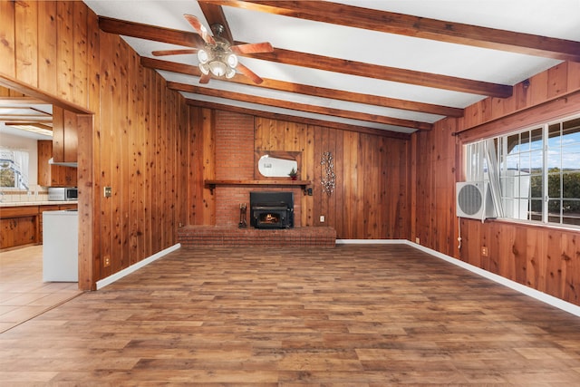 40836 W 36th St, Palmdale, CA 93551 - unfurnished living room with beamed ceiling, healthy amount of natural light, wooden walls, wood finished floors, and ceiling fan