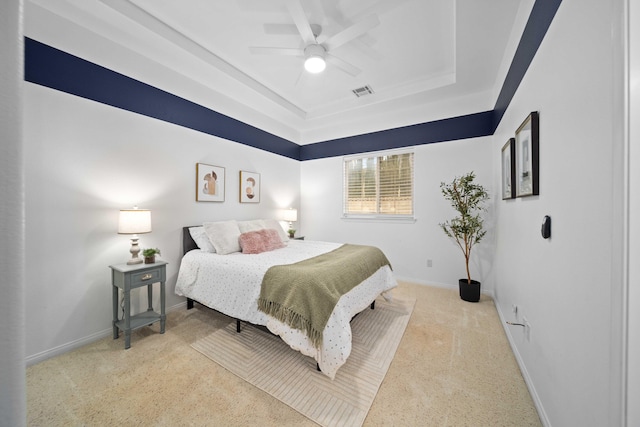 bedroom with visible vents, ceiling fan, baseboards, a tray ceiling, and carpet floors