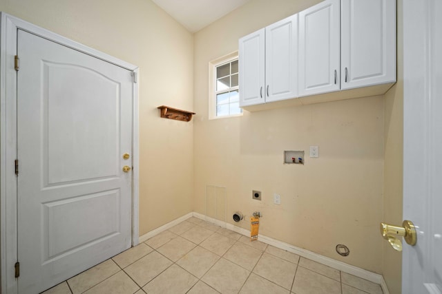 clothes washing area with visible vents, light tile patterned flooring, cabinet space, electric dryer hookup, and washer hookup