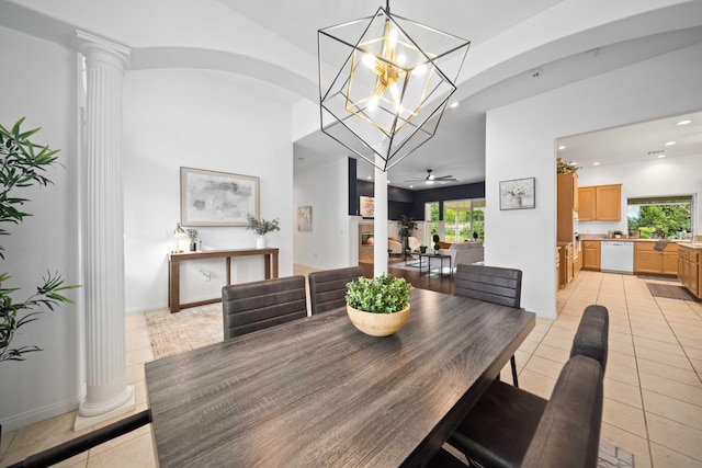 dining room with decorative columns, recessed lighting, arched walkways, and light tile patterned floors