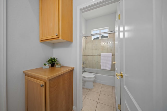 full bath with tile patterned floors, toilet, and enclosed tub / shower combo