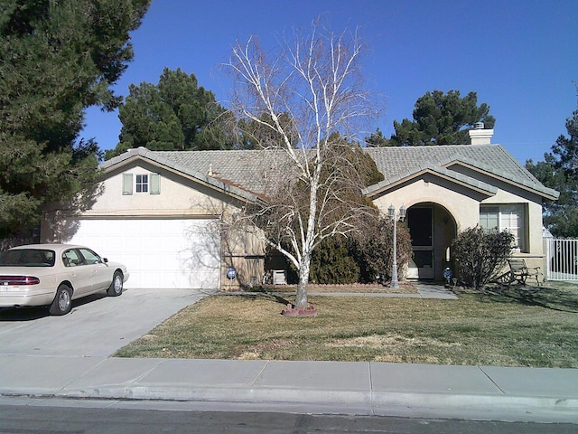 view of front facade featuring a garage and a front lawn