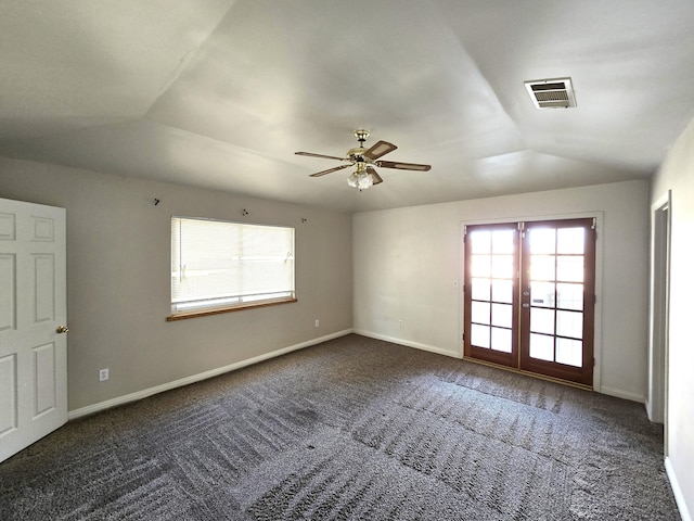 carpeted empty room featuring lofted ceiling, french doors, and ceiling fan