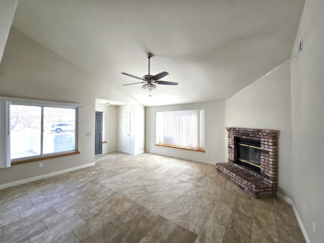 unfurnished living room with vaulted ceiling, a brick fireplace, and ceiling fan