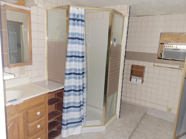 bathroom with tile patterned floors, tile walls, a shower with curtain, and vanity