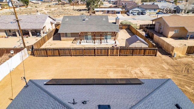 exterior space with a residential view and a fenced backyard