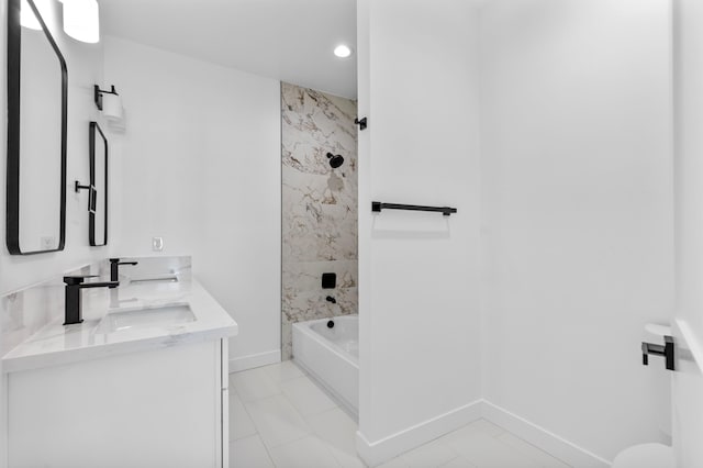 bathroom featuring vanity, shower / tub combination, and baseboards