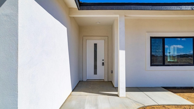 doorway to property with stucco siding