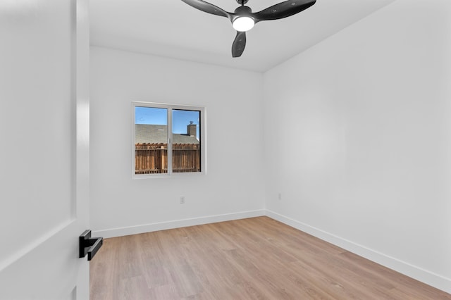 empty room with light wood-style flooring and baseboards