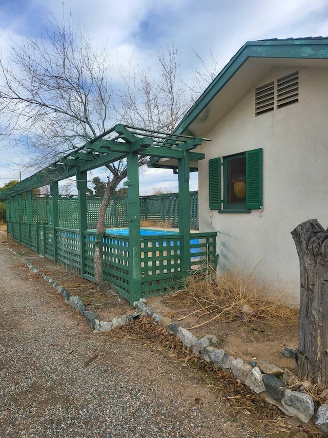 exterior space with fence and stucco siding