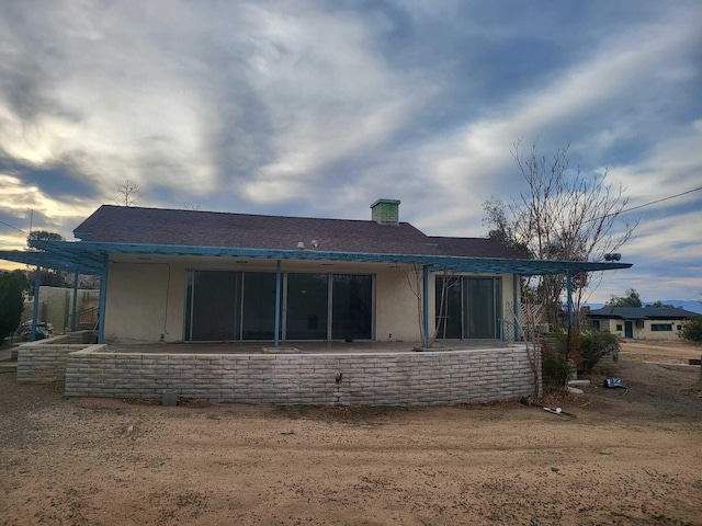 back of property featuring stucco siding and a patio