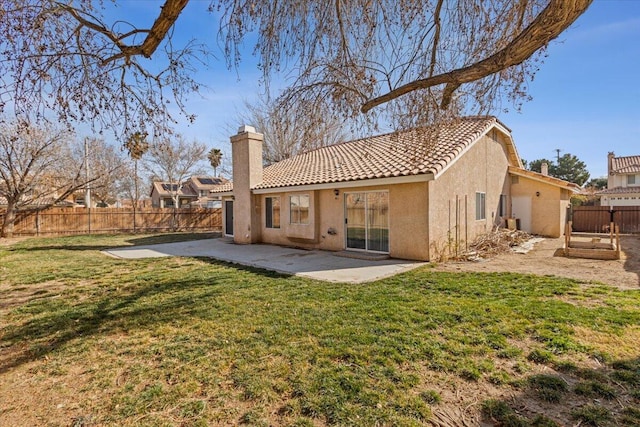 rear view of property with a lawn and a patio area