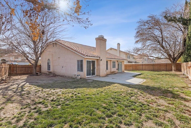 back of house with a yard and a patio area