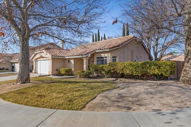 view of front of property featuring a garage and a front lawn