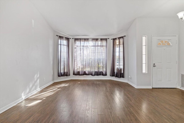 entrance foyer featuring a healthy amount of sunlight and dark hardwood / wood-style floors