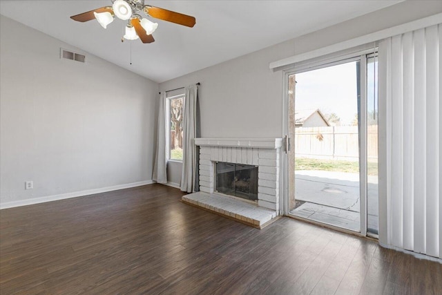 unfurnished living room featuring dark hardwood / wood-style flooring, a fireplace, vaulted ceiling, and ceiling fan