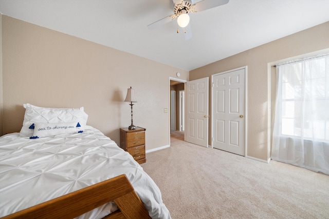 bedroom featuring ceiling fan and light colored carpet