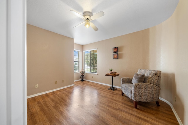 living area with ceiling fan and hardwood / wood-style flooring