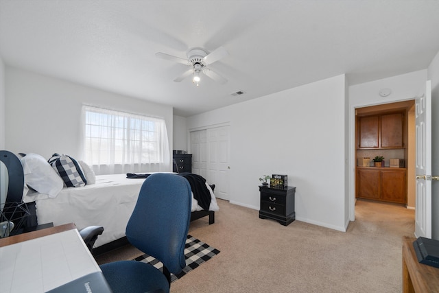 bedroom with light carpet, a closet, and ceiling fan